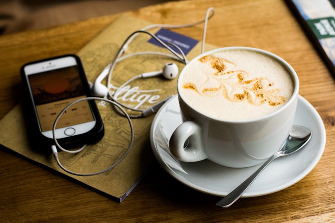 7 Christmas podcasts - coffee with phone and headphones