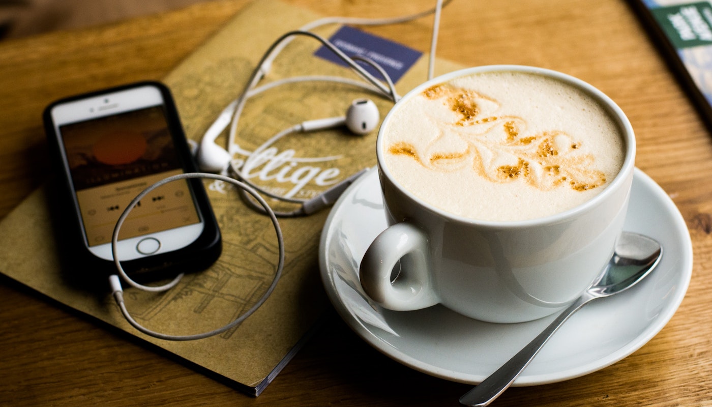 7 Christmas podcasts - coffee with phone and headphones