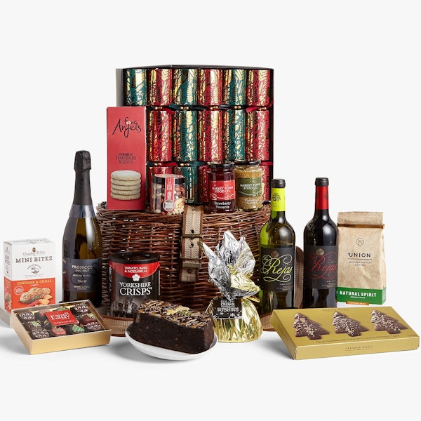 Festive Fireside Hamper, John Lewis, £125 Perfect for fireside indulgence, or to make your party go with a bang, this smart little hamper contains three bottles of wine, cake, Christmas pud, crisps, chocs and even crackers. Don’t mind if we do.