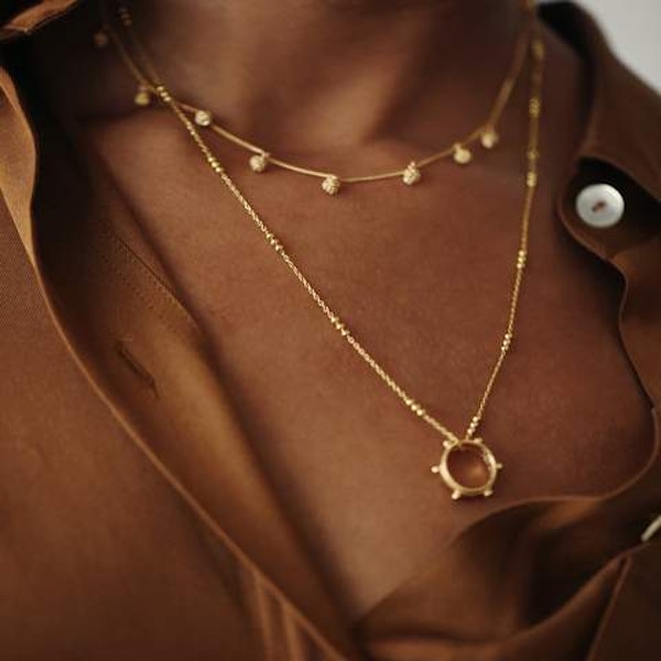 Daisy Jewellery: Stacked Knot Charm Necklace, £149 A great mid-length necklace with delicate knotted detailing along its length. The perfect foil to balance out other necklaces with a more central focus, such as a bar or pendant.