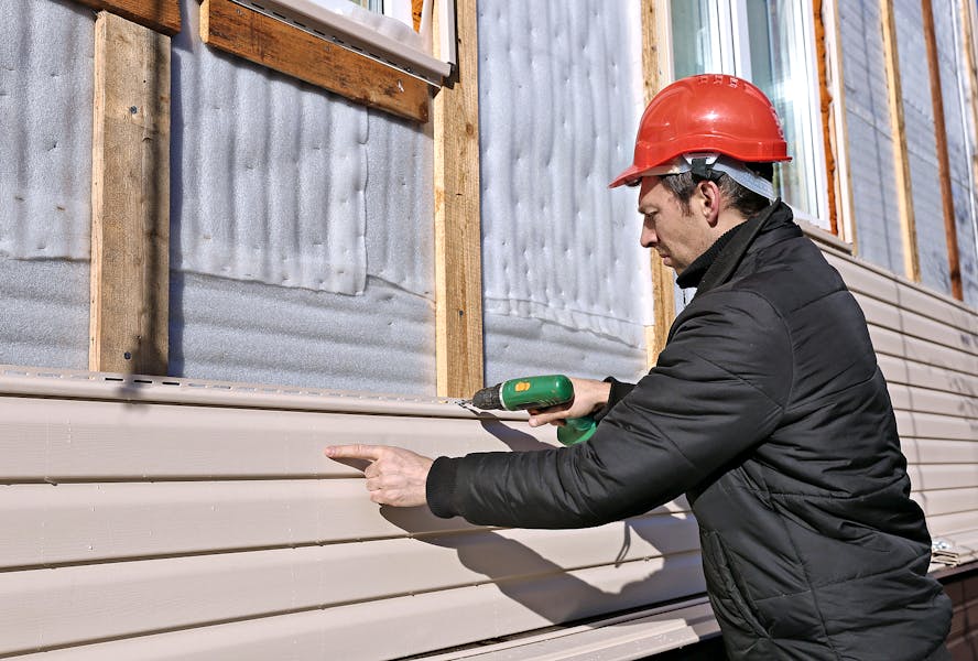 Bigstock-A-Worker-Installs-Panels-Beige-110603573