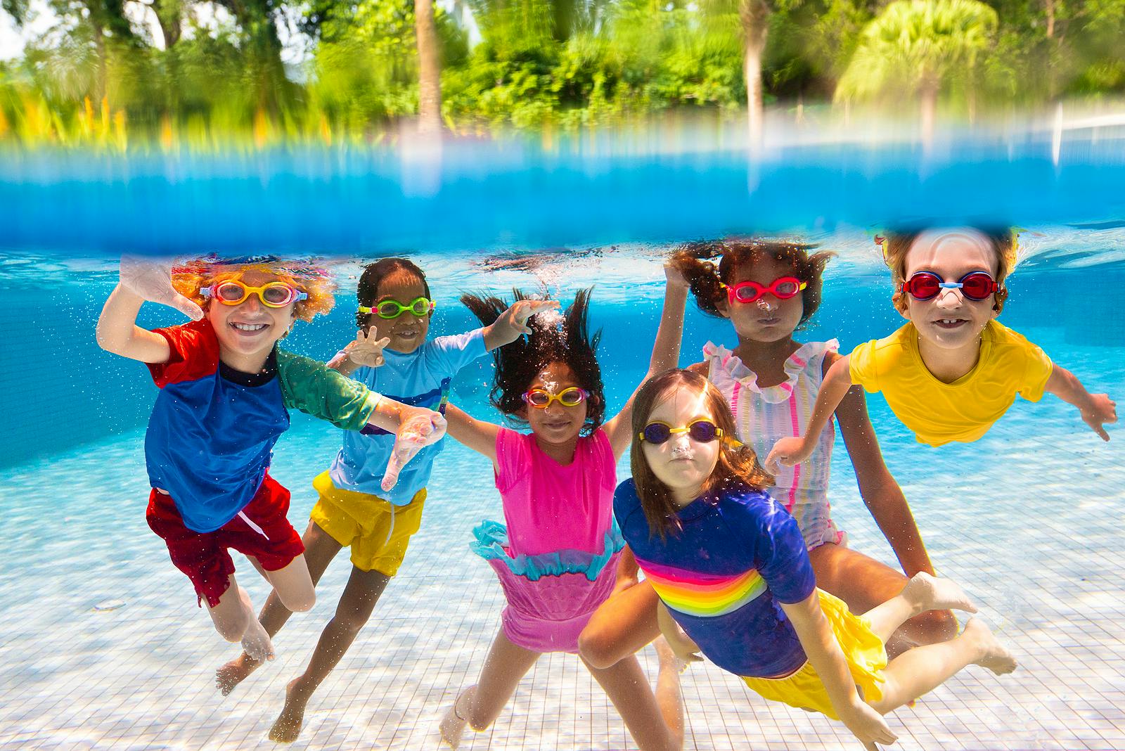 Bigstock-Group-Of-Kids-Jump-Into-Swimmi-476616453