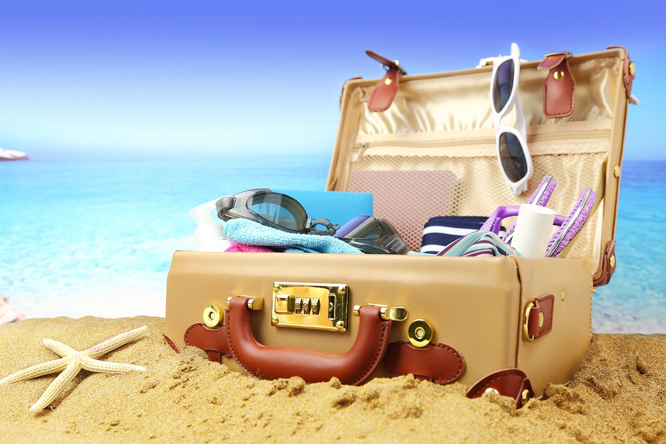 Bigstock-Full-open-suitcase-on-tropical-63865936