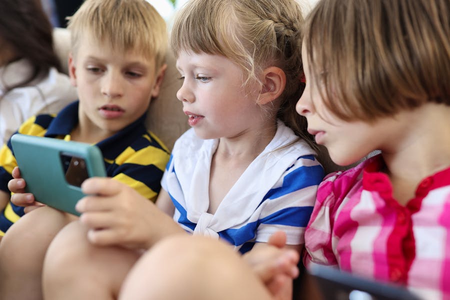 Bigstock-Three-Children-Are-Sitting-On--384583961