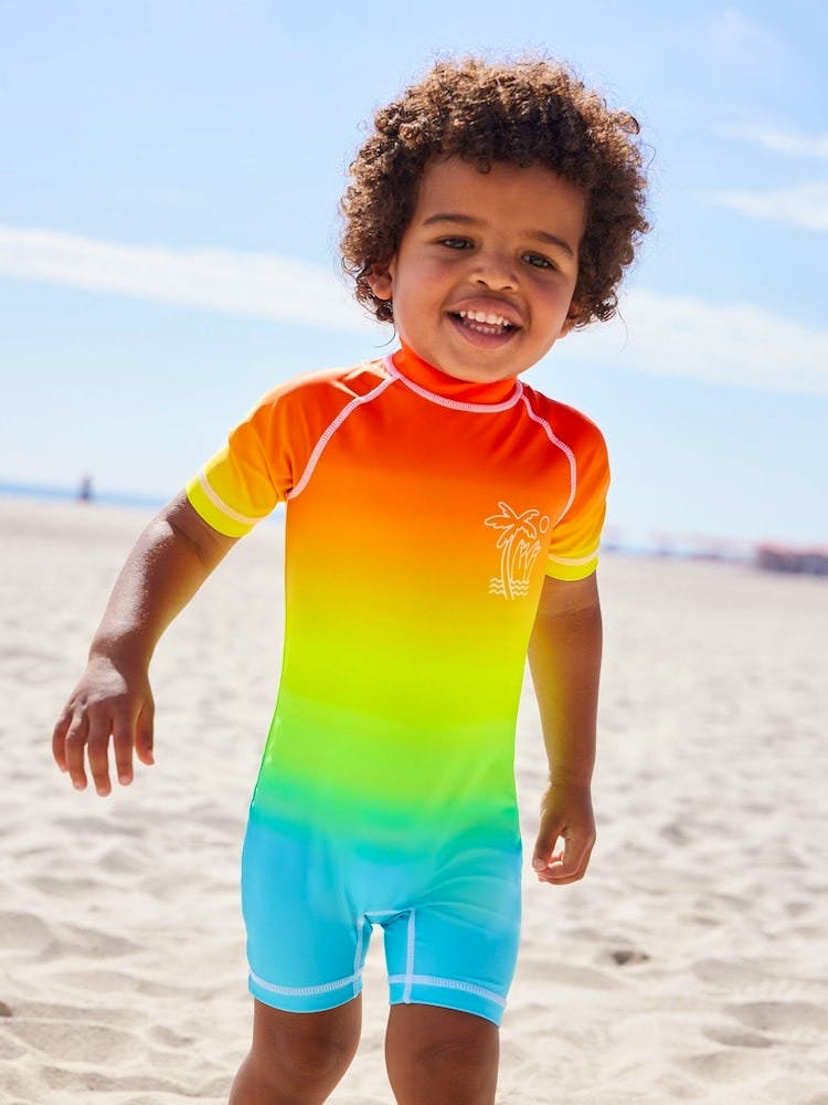 Next Rainbow Dip Dye Sunsafe All-In-One Swimsuit (3mths-7yrs), £12-16