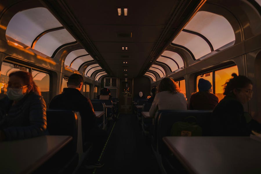 A group of people sitting on a train next to each other photo – Free Sunset Image on Unsplash Levi-meir-clancy