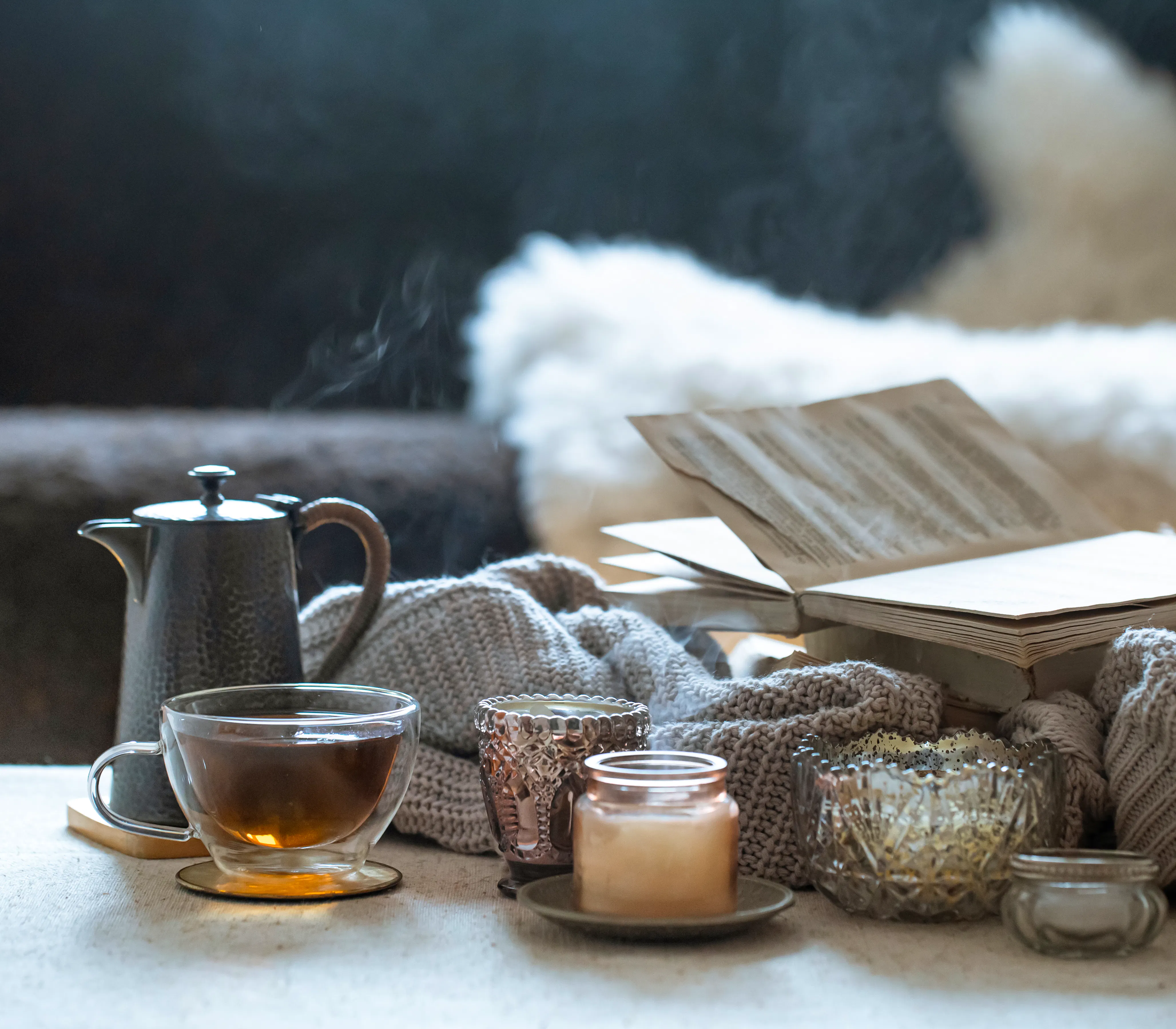 Still-life-with-cup-tea-teapot-book-beautiful-vintage-candlesticks-with-candles-home-decor-concept