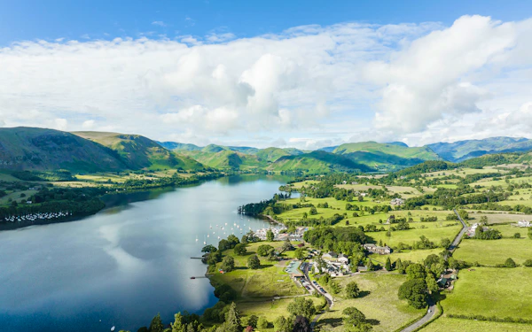 Aerial view of Ullswater in the Lake District, with green fells, farmland and the lakeside near Another Place